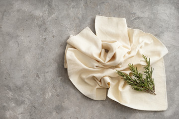 Fototapeta na wymiar Fabric with fresh rosemary on grey table