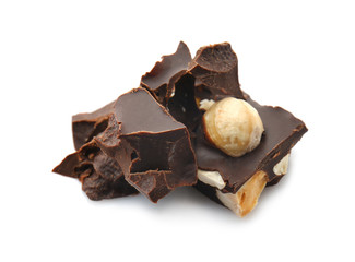 Pieces of tasty dark chocolate with nuts on white background