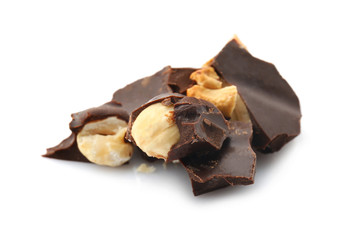 Pieces of tasty dark chocolate with nuts on white background
