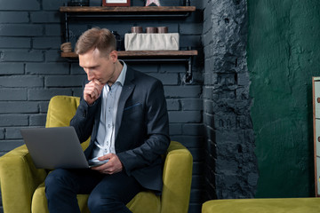 man sitting on bench and reading book