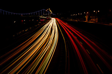 Fototapeta na wymiar The car light trails on the highway in the night modern city