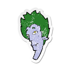 retro distressed sticker of a cartoon vampire head