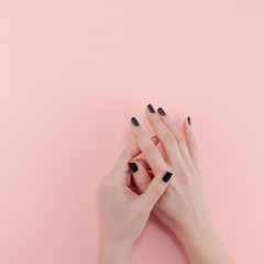 Woman's hands with black manicure