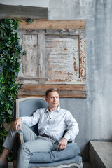 man sitting on sofa and looking at camera
