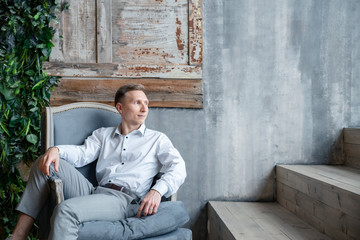 man sitting on sofa and talking on cell phone