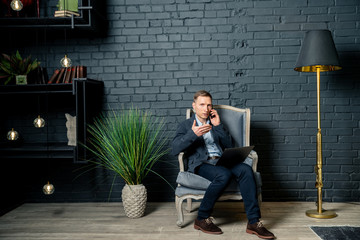businessman sitting on the floor and working on laptop