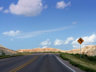 Scenic loop byway at the Badlands National Park in South Dakota, USA, with an arrow on the roadside. 
