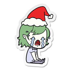 sticker cartoon of a crying vampire girl wearing santa hat