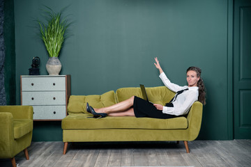 woman sitting on sofa and watching tv