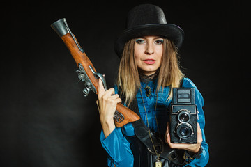 Steampunk with old retro camera and pistol.