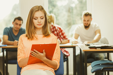Student girl in front of her mates in classroom