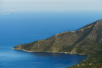 Summer time in Greece. Beautiful Greek coastline next to sea shore during warm weather.