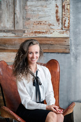 portrait of young woman in front of brick wall