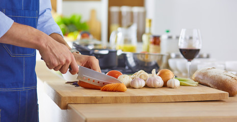 Young chef prepares a man in the kitchen