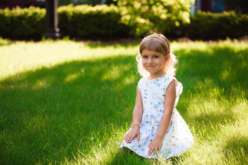 Beautiful little young girl outdoorin a park.