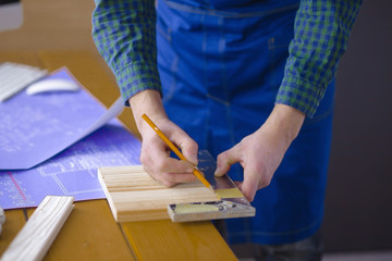Engineer carpenter working on laptop and sketching project