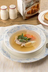 Dietary soup with chicken and egg on wooden table