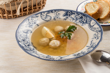 Dietary soup with chicken and egg on wooden table