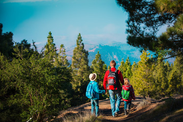 Obraz premium father with son and daughter hiking in nature