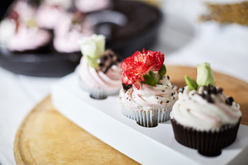 Tasty cupcakes on a white wooden table