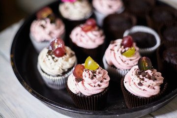Tasty cupcakes on a white wooden table