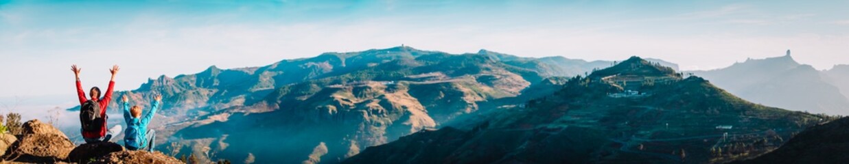 happy father and son hiking in mountains, family travel in nature