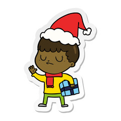 sticker cartoon of a grumpy boy wearing santa hat