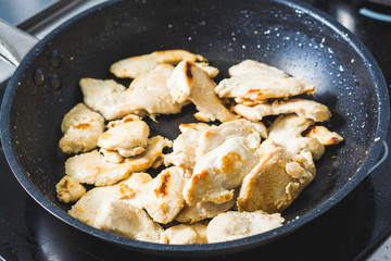 Frying tasty chicken meat for lunch time
