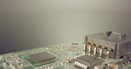 Extreme macro dolly shot of a PCB computer board with capacitors and transistors