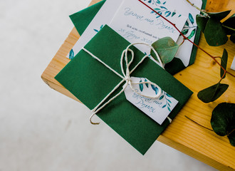 Wedding Invitation Cards Papers Laying on table 