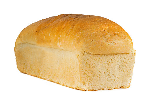 A traditional  square loaf of bread is isolated on a white background. bread isolated on a white background. square loaf of bread with two pieces cut off on a white background. 