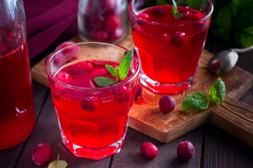 Cranberry juice from frozen cranberries on a wooden board, horizontal