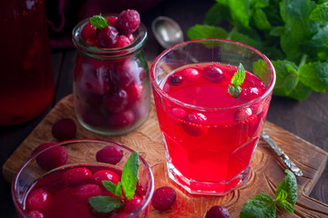 Cranberry juice from frozen cranberries on a wooden board, horizontal