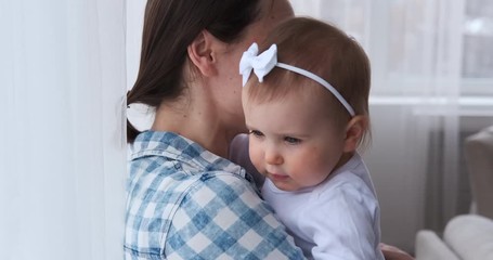 Happy mother dancing with her cute baby girl at home