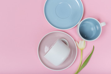 Clean dishes, coffee or tea set on pink background