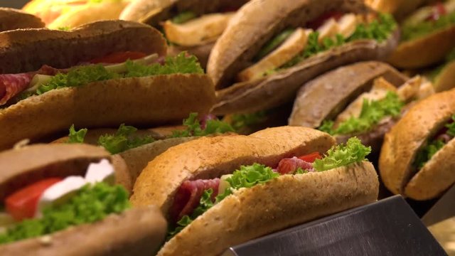 Closeup on sub sandwiches on display on a counter in a store
