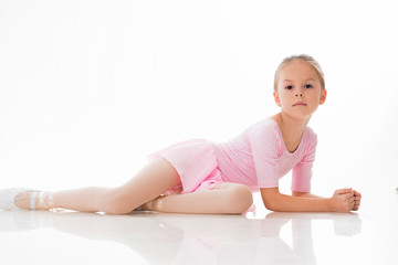 The little ballerina, the girl in a dancing suit on a white background