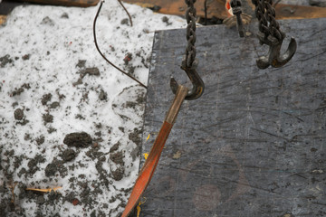 Details of the beam discharge port crane mechanism with chains and hooks.