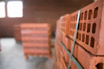 Stack of red clay brick on construction site