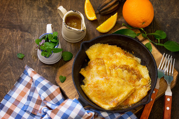 Homemade French pancakes - Crepe Suzette with orange syrup for a delicious breakfast. Copy space.