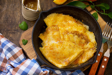 Homemade French pancakes - Crepe Suzette with orange syrup for a delicious breakfast. Copy space.
