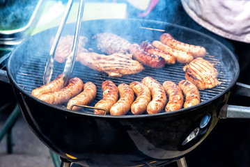 Delicious sausages and meat on a metal grid
