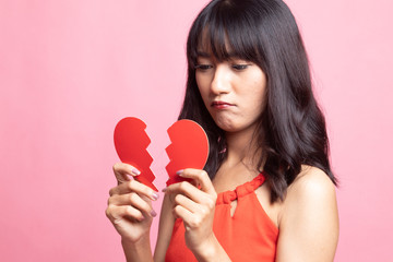 Beautiful young Asian woman with broken heart.