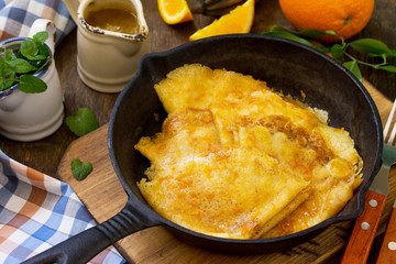 Homemade French pancakes - Crepe Suzette with orange syrup for a delicious breakfast.