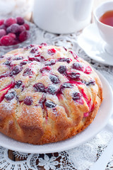 Cranberry pie and apples on a wooden table, selective focus
