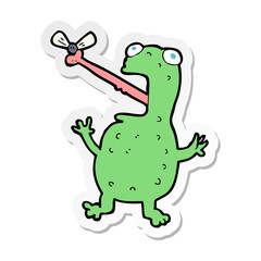 sticker of a cartoon frog catching fly