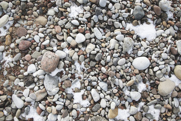 pebbles and snow on the beach texture