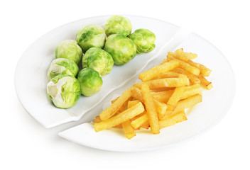 Healthy nutrition diet concept. French fries and brussels sprouts. Healthy and unhealthy junk food.