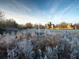Frosty winter sunrise with a hoarfrost view of St Cross Hospital, Winchester, Hampshire, UK