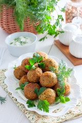 Obraz na płótnie Canvas Chickpea falafel with fresh herbs on a white plate, selective focus